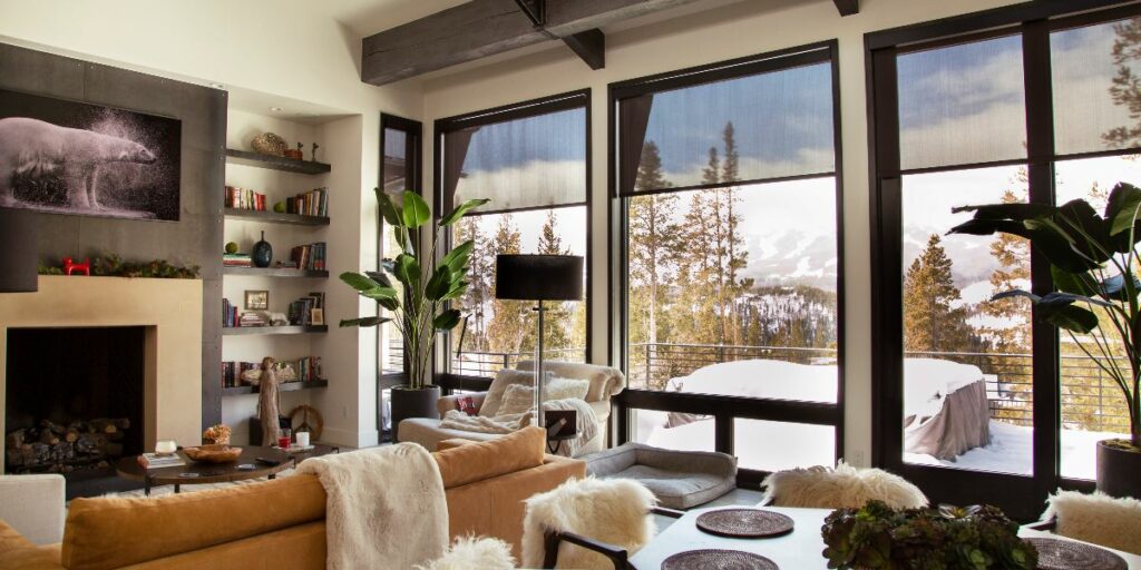 Home entertainment system in living room overlooking snow-covered porch in rural Colorado.