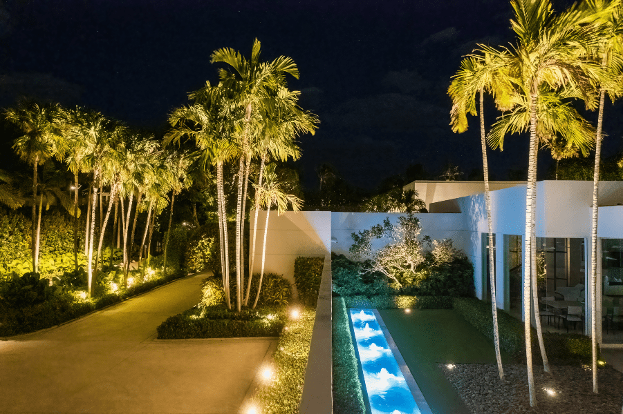 Exterior short of driveway adjacent alleyway in Florida home, landscape lighting, ETC